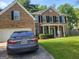Beautiful two-story brick home with a well-manicured lawn and mature trees providing shade at 692 Sedgwick Dr, Jonesboro, GA 30238