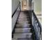Carpeted staircase with a dark railing leading to the upper level of the home at 692 Sedgwick Dr, Jonesboro, GA 30238