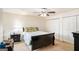 Cozy bedroom featuring a ceiling fan, carpeted floors, and ample closet space for storage at 1017 Camelot Dr, Atlanta, GA 30349