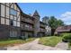 Three-story apartment building with brick and siding exterior, multiple balconies, and unique turret design at 1017 Camelot Dr, Atlanta, GA 30349