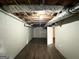 Unfinished basement features exposed pipes and ceiling and wood flooring at 3670 Broadview Ct, Decatur, GA 30032