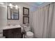 Neutral bathroom with a shower and a vanity with dark wood finish and art on the wall at 123 Mill, Dallas, GA 30157