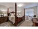 Bedroom featuring a four poster bed with plush bedding and neutral decor at 123 Mill, Dallas, GA 30157