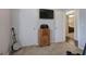 Bedroom featuring vintage radio on wood stand, large TV, carpet, and banjo at 123 Mill, Dallas, GA 30157