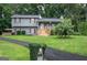 Attractive split-level home with well-kept lawn, mature trees, and charming front porch at 123 Mill, Dallas, GA 30157
