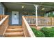 Inviting front porch with natural wood stairs and a cozy swing for outdoor relaxation at 123 Mill, Dallas, GA 30157