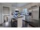 Bright kitchen with stainless steel appliances, white cabinetry, and center island with seating at 123 Mill, Dallas, GA 30157