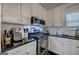 Stylish kitchen featuring stainless steel appliances, ample counter space, and modern finishes at 123 Mill, Dallas, GA 30157