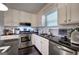 Well-equipped kitchen featuring stainless steel appliances and dark countertops at 123 Mill, Dallas, GA 30157