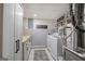 Basement laundry room features white cabinetry, tile flooring and a washer/dryer at 123 Mill, Dallas, GA 30157