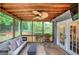 Enjoy nature views from the screened porch with a ceiling fan and comfortable outdoor furniture at 123 Mill, Dallas, GA 30157