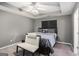 Large bedroom with a tray ceiling, fan, and neutral decor at 1765 Neighborhood Walk, Mcdonough, GA 30252