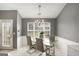 View of a dining room with tile floors and a modern glass table and seating at 1765 Neighborhood Walk, Mcdonough, GA 30252