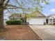 Charming single-Gathering home with a two-car garage and mature tree in the front yard at 1765 Neighborhood Walk, Mcdonough, GA 30252