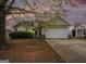 Charming single-Gathering home with a two-car garage and mature tree in the front yard at 1765 Neighborhood Walk, Mcdonough, GA 30252