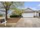 View of a single-Gathering home with a two-car garage and mailbox at 1765 Neighborhood Walk, Mcdonough, GA 30252