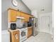 A well lit kitchen featuring stainless steel appliances and tile flooring at 1765 Neighborhood Walk, Mcdonough, GA 30252