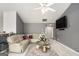 View of a living room with neutral colors, a large sectional sofa, and an entertainment center at 1765 Neighborhood Walk, Mcdonough, GA 30252