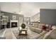 View of a living room featuring a fireplace, large sectional sofa, and bar seating at 1765 Neighborhood Walk, Mcdonough, GA 30252