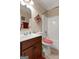 Well-maintained bathroom with a dark wood vanity, a standard toilet and a tub-shower combo at 409 Brandy Ln, Mcdonough, GA 30253