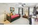 Bright bedroom featuring a red daybed, ceiling fan, and comfortable sitting area at 1386 Sheffield Glen Ne Way, Atlanta, GA 30329