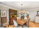 A dining area with hardwood floors, chandelier, and a stylish hutch for added character at 1386 Sheffield Glen Ne Way, Atlanta, GA 30329
