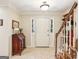 Bright foyer with tiled floor, staircase, and decorative writing desk at 1386 Sheffield Glen Ne Way, Atlanta, GA 30329