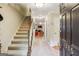 Inviting foyer with tiled floor, staircase, and view to the living room at 1386 Sheffield Glen Ne Way, Atlanta, GA 30329