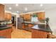 Open kitchen with wood cabinets, stainless steel appliances, and island at 1386 Sheffield Glen Ne Way, Atlanta, GA 30329