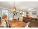 A dining area adjacent to living room features hardwood floors and an elegant light fixture at 1386 Sheffield Glen Ne Way, Atlanta, GA 30329