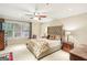 Cozy main bedroom featuring a large window, ceiling fan, and decorative floral bedding at 1386 Sheffield Glen Ne Way, Atlanta, GA 30329