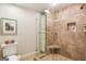 Tiled walk-in shower complete with glass door, corner seat, and recessed shelving at 1386 Sheffield Glen Ne Way, Atlanta, GA 30329