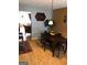 Bright dining room with wood floors, modern lighting, and adjacent living area at 5658 Wind Gate Ln, Lithonia, GA 30058