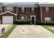 Traditional brick townhome with front yard and attached one car garage at 5658 Wind Gate Ln, Lithonia, GA 30058
