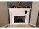 Close-up view of the fireplace with white mantle and decorative objects at 5658 Wind Gate Ln, Lithonia, GA 30058