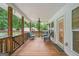 Charming back porch with wood flooring, outdoor seating, and ceiling fan, perfect for relaxation and entertaining at 5745 Westwood Dr, Cumming, GA 30040