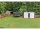Backyard with storage shed, trampoline and a wooden fence at 5745 Westwood Dr, Cumming, GA 30040