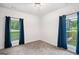 Bright bedroom with natural light, carpet, and blue curtains, creating a cozy and inviting atmosphere at 5745 Westwood Dr, Cumming, GA 30040