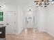 Bright entryway featuring wood-look floors, white trim, rustic lighting and a frosted glass front door at 5745 Westwood Dr, Cumming, GA 30040