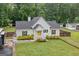 Front exterior with yellow front door and well-manicured lawn at 5745 Westwood Dr, Cumming, GA 30040