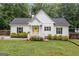 Charming single-story home with a yellow front door, well-manicured lawn, and lush green shrubbery at 5745 Westwood Dr, Cumming, GA 30040