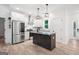 Kitchen featuring stainless steel appliances, an island with granite countertops, and a view of the dining room at 5745 Westwood Dr, Cumming, GA 30040