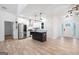 Open kitchen with stainless steel appliances, island with granite countertops and a clear view to the entryway at 5745 Westwood Dr, Cumming, GA 30040