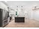 Kitchen with stainless steel appliances, island with granite countertops, and white cabinets with chrome hardware at 5745 Westwood Dr, Cumming, GA 30040