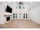 Vaulted living room with wood floors and a cozy fireplace with access to the pool at 5745 Westwood Dr, Cumming, GA 30040