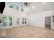 Large living room with vaulted ceilings and fireplace with access to side yard at 5745 Westwood Dr, Cumming, GA 30040