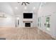 Bright living room features a fireplace, vaulted ceilings, and wood flooring at 5745 Westwood Dr, Cumming, GA 30040