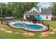Backyard pool area with patio, lounge chairs, and a view of the home's deck and well-maintained lawn at 5745 Westwood Dr, Cumming, GA 30040