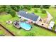 Aerial view of a home's backyard featuring a pool, deck, and ample green space at 1195 New Hope Rd, Locust Grove, GA 30248