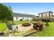 Spacious backyard featuring a fire pit, deck with pergola, and outdoor seating area perfect for entertaining at 1195 New Hope Rd, Locust Grove, GA 30248